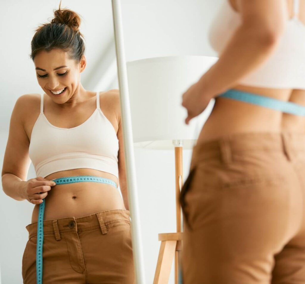 reflection-in-a-mirror-of-happy-woman-measuring-he-2023-11-27-04-56-17-utc (3)