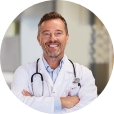 smiling-mature-doctor-in-hospital-hallway-2023-11-27-05-34-44-utc