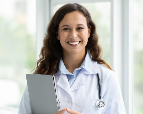 woman-doctor-standing-by-window-holding-laptop-2024-01-09-07-12-14-utc (1)